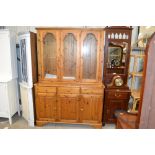 A modern pine and glazed three drawer dresser