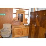 A large stripped pine and mirrored back sideboard