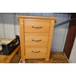 A light oak veneered three drawer bedsdie chest