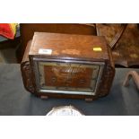 An oak cased three hole mantel clock