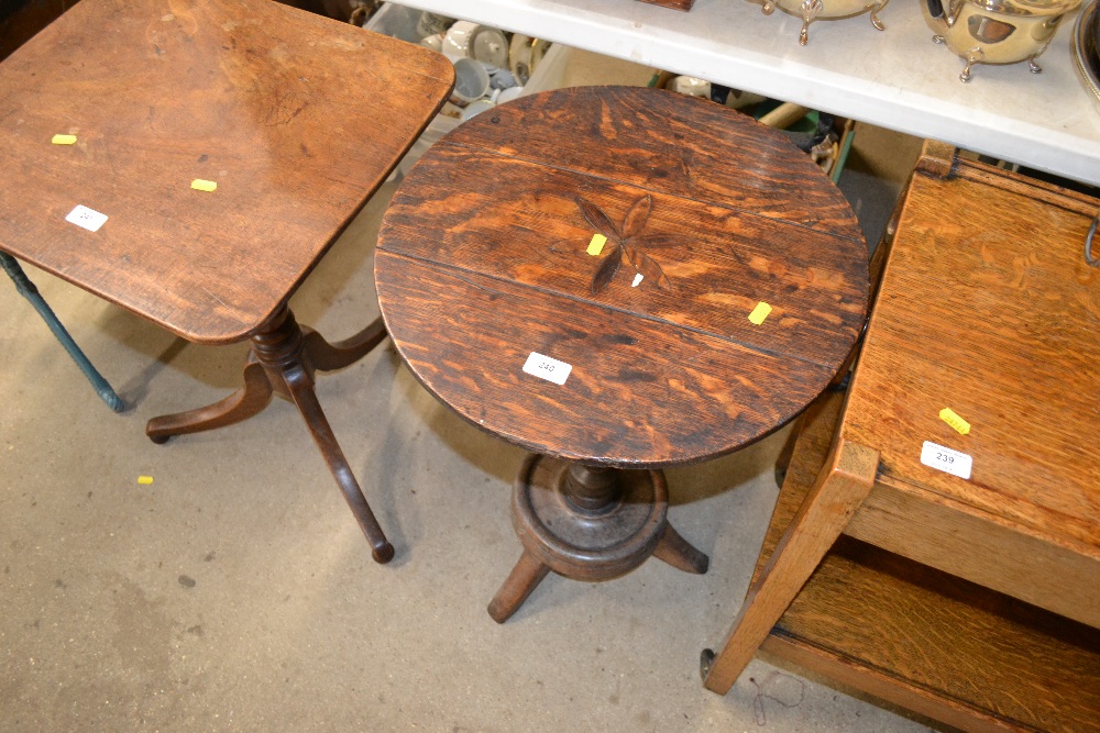 An oak circular topped occasional table inlaid wit