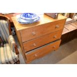 A stripped pine three drawer chest