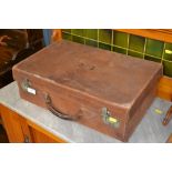 A small brown leather suitcase initialled E.C.