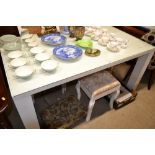 A white painted glass topped dining table with a s