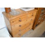 A stripped pine chest fitted two short over three