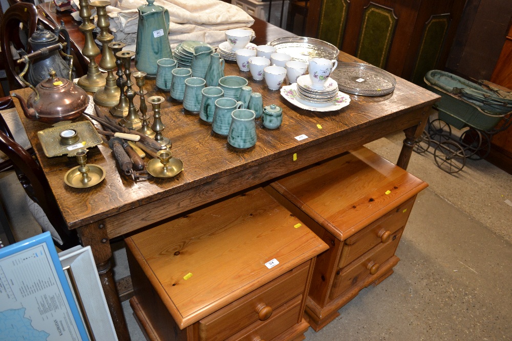 An oak oblong kitchen table raised on stretcher ba