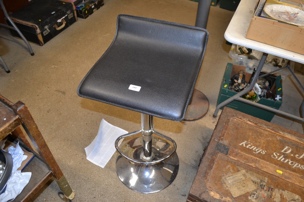 A chrome and leather topped adjustable high stool