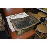 A wicker picnic basket and one other wicker basket