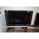 A JVC flat screen TV with remote control