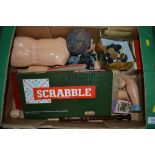 A box containing various doll parts; Scrabble boar