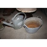 A small galvanised bath and watering can