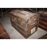 A metal and wooden bound dome top trunk