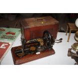 A Singer sewing machine in mahogany case