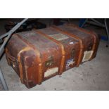 A wooden bound travelling trunk