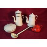 A quantity of enamelware to include two jugs,a lad