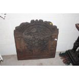 A large ornate cast iron fire back