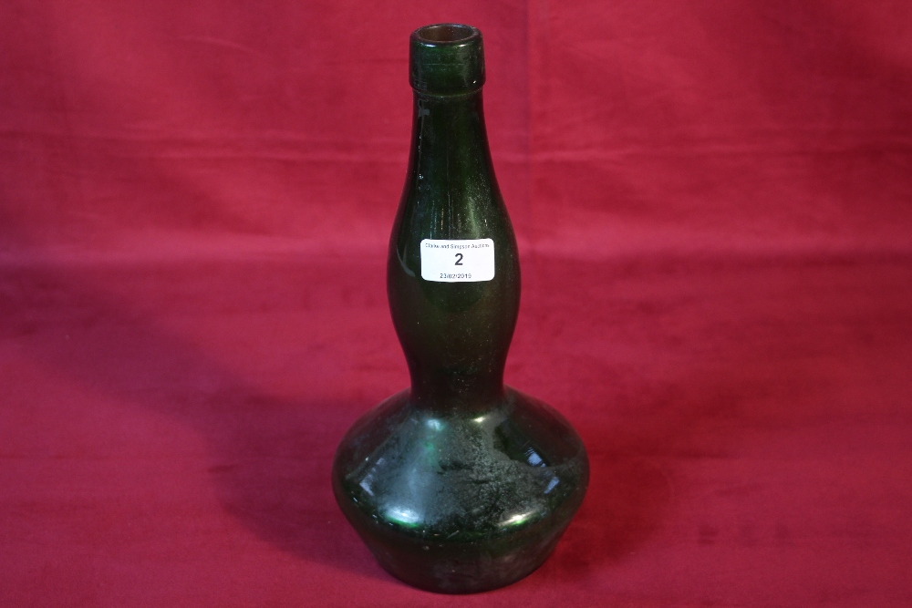 A green glass shaped bottle