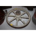 A small wooden and metal wheel barrow wheel