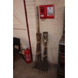 A quantity of long handled tools, including rake,