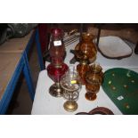 Four glass and brass oil lamps