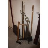 A quantity of long handled tools including axe, pi