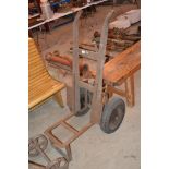 An unusual wooden and metal sack barrow on pneumatic tyres with raised base