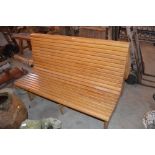 A large oak double sided slatted bench