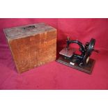 A Wilcox & Gibbs sewing machine with pine case