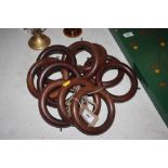 A quantity of large wooden curtain rings