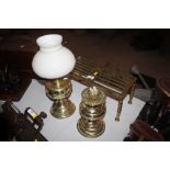 A brass footman and two brass oil lamp bases, one