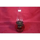 A cranberry glass base oil lamp