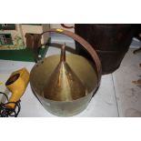 A brass funnel and brass jam pan