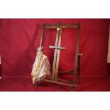 An oak adjustable easel; two small artists mannequ