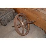 An old metal ornate wheel barrow wheel