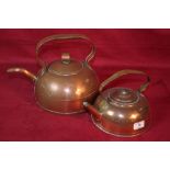 Two shaped copper kettles