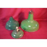 Three various sized green enamel light shades