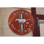 A circular "Ford Mustang" enamel sign, 18" dia. approx.