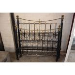 An ornate brass and iron bed with irons and spring
