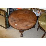 A circular topped coffee table raised on claw and