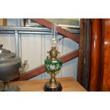 A late Victorian brass and green glass oil lamp wi