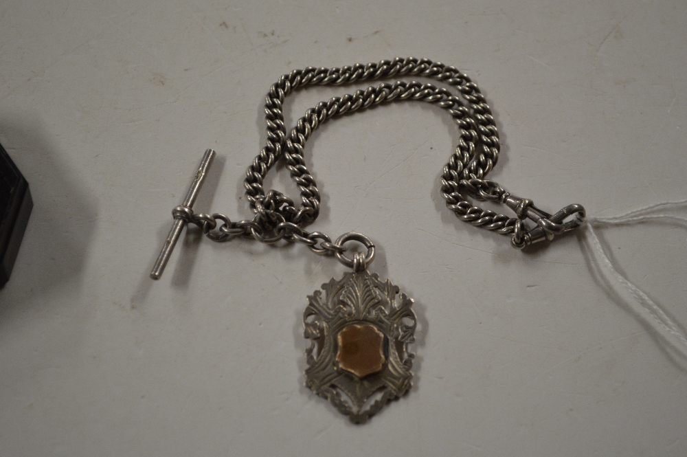 A silver pocket watch chain and fob