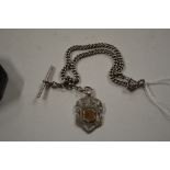 A silver pocket watch chain and fob