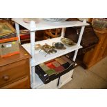 A white painted three tier buffet raised on cupboa