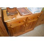 A modern pine two drawer side cupboard