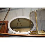 A white painted oval and bevelled edge mirror