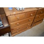 A modern stripped pine chest, fitted two short ove