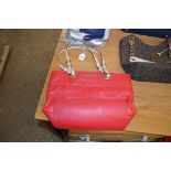 A Michael Kors red leather handbag