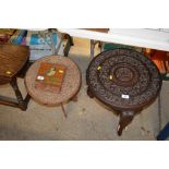 An Indian carved hardwood table raised on elephant