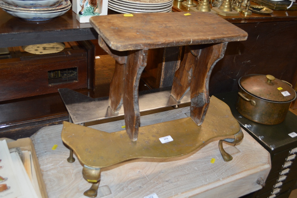 A small rustic wooden stool; a brass footman and a