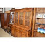 A good quality oak glazed bookcase, raised on thre